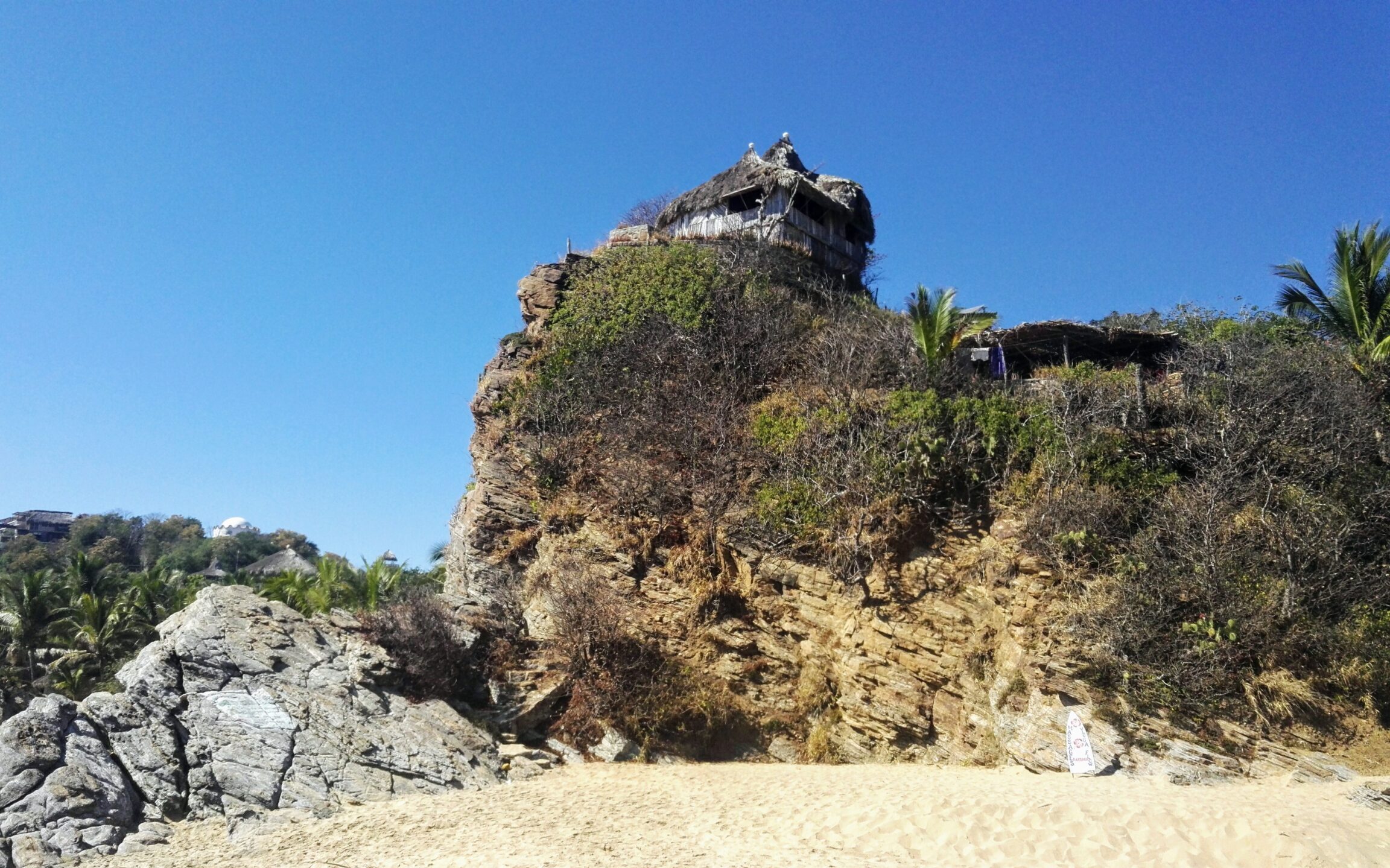 little hut on the cliff above the beach