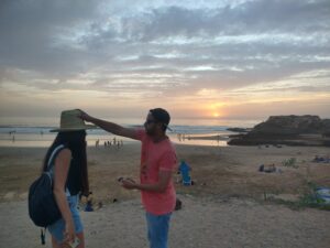 mate putting head in friends head infront of sunset beach