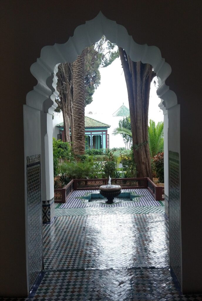 view out to courtyard, tiled floor, little fountain in between trees